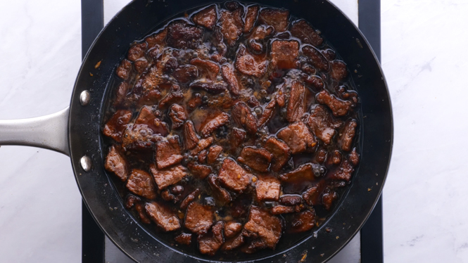 tossing flank steak in mongolian sauce